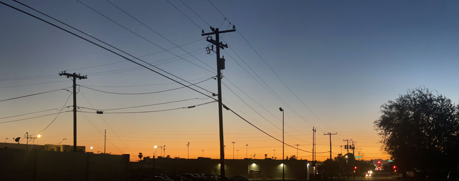 Photo of Red Sunset Behnd Power Lines.